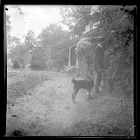 Man with a dog in front of Bayside Plantation house, Pasquotank County, North Carolina